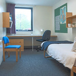 Spacious bedroom with storage, desk and chair